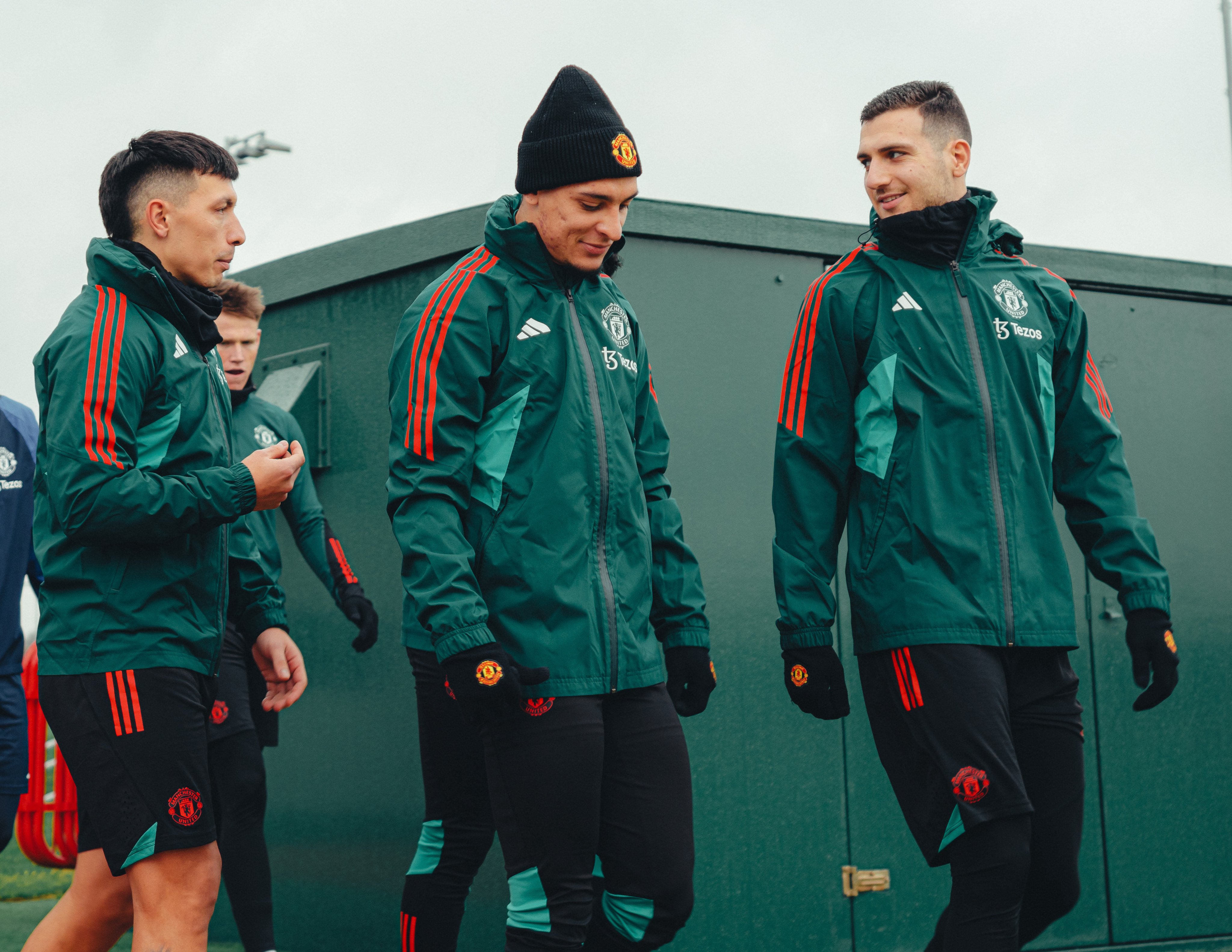 Lisandro Martinez, Antony and Diogo Dalot walk out for training at Carrington.