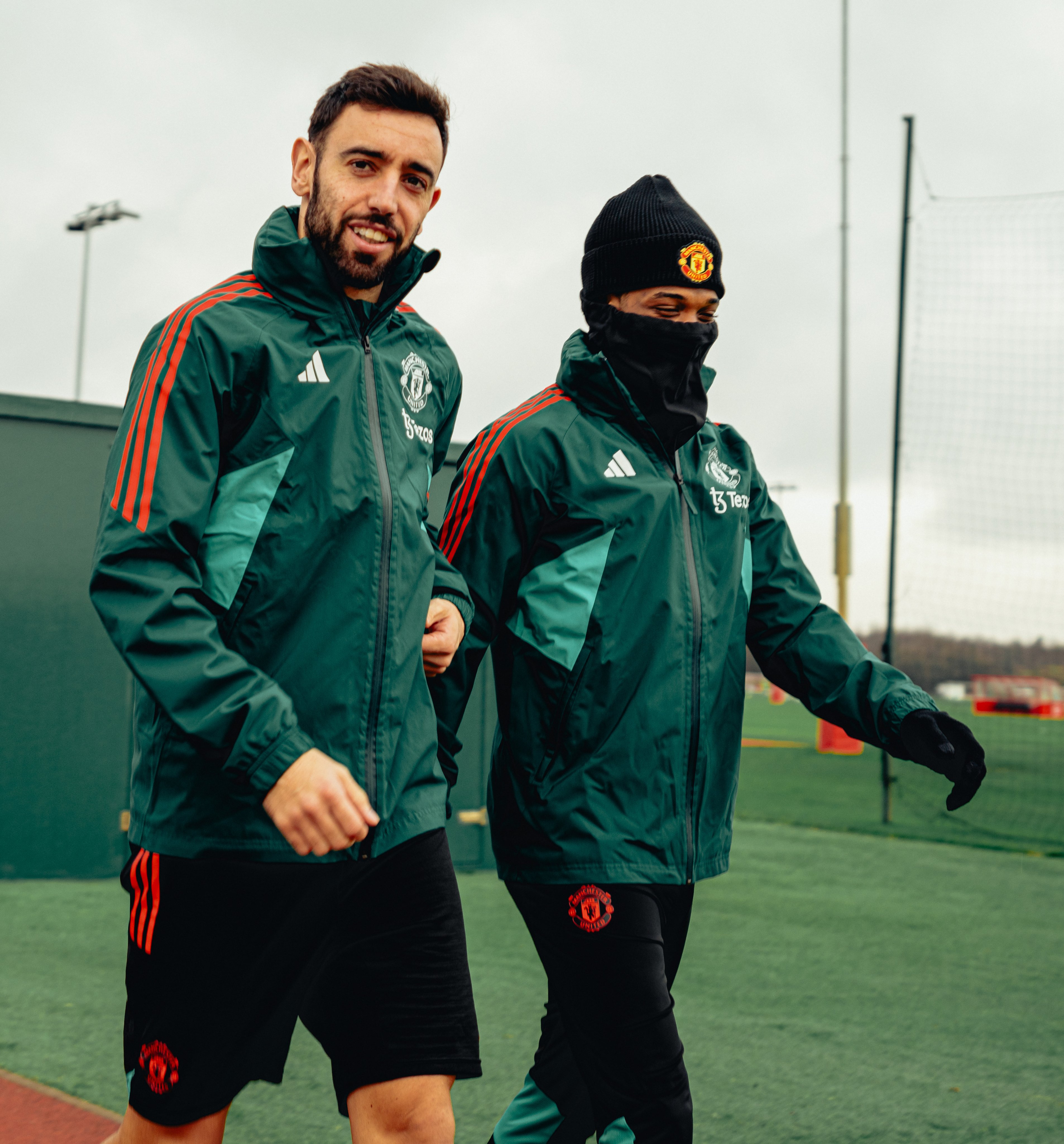 Bruno Fernandes walks out for training alongside Amad.