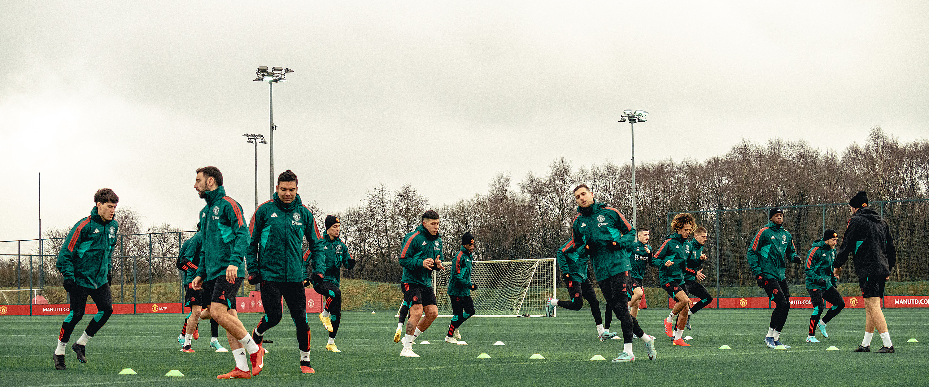 The United squad warm-up at Carrington on the training pitch.