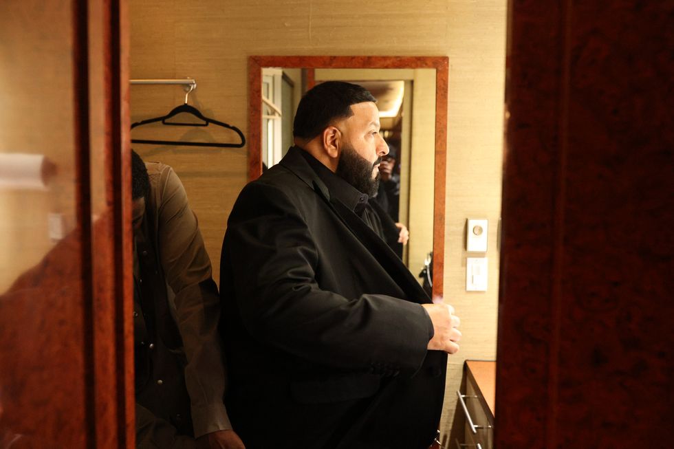 dj khaled slipping into his suit jacket