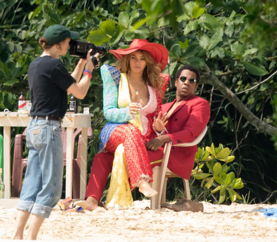 Beyonce cuddles up to husband Jay-Z in plunging rainbow-coloured suit as  couple film together in Jamaica | The Sun