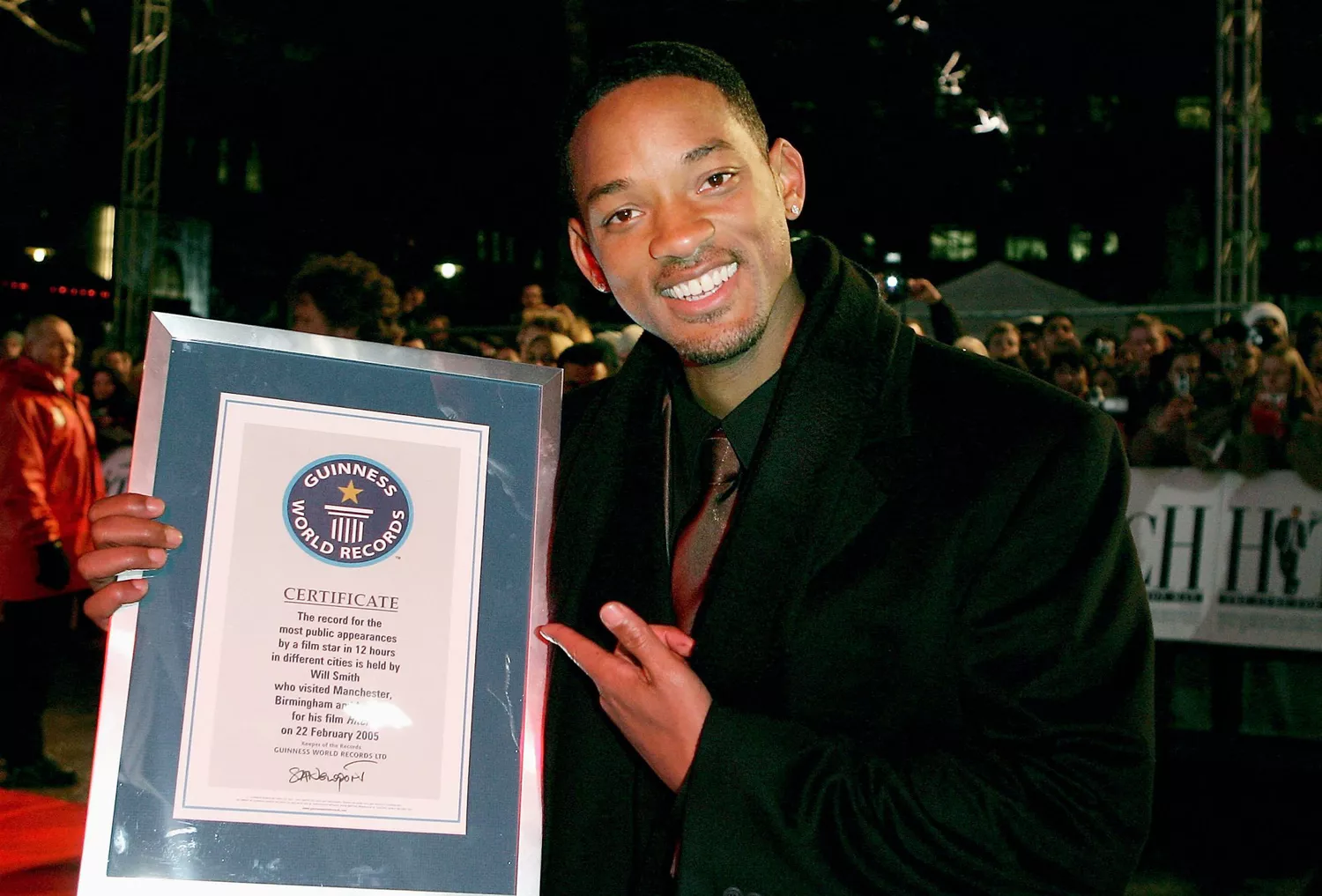 Actor Will Smith poses with his certificate for breaking the Guinness World Record for the most public appearances in different cities in 12 hours (having also appeared at Premieres in Birmingham and Manchester) at the "Hitch" UK Premiere at Odeon Leicester Square on February 22, 2005 in London.