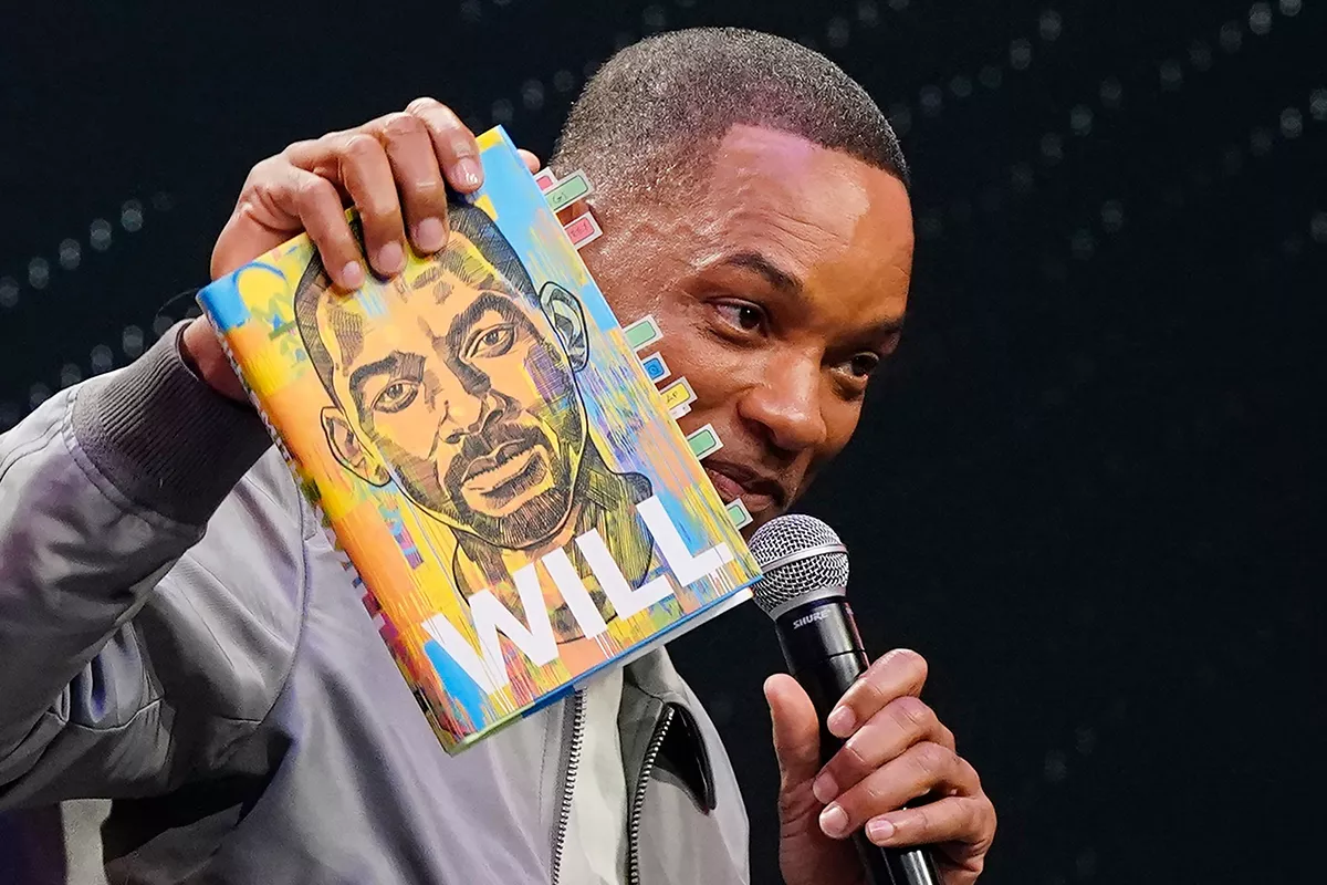 Will Smith holds a copy of his book during an event promoting his new memoir "Will," in Philadelphia People Will Smith, Philadelphia, United States - 08 Nov 2021