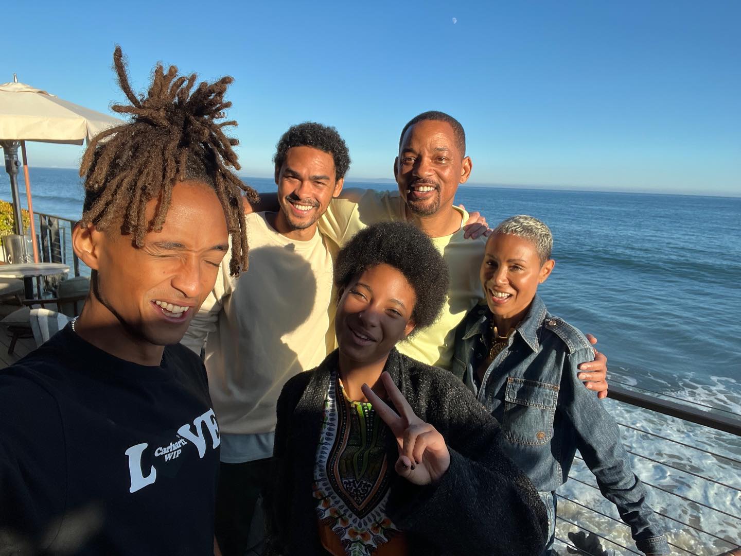 Will Smith and Jada Pinkett Smith and their kids taking a selfie.