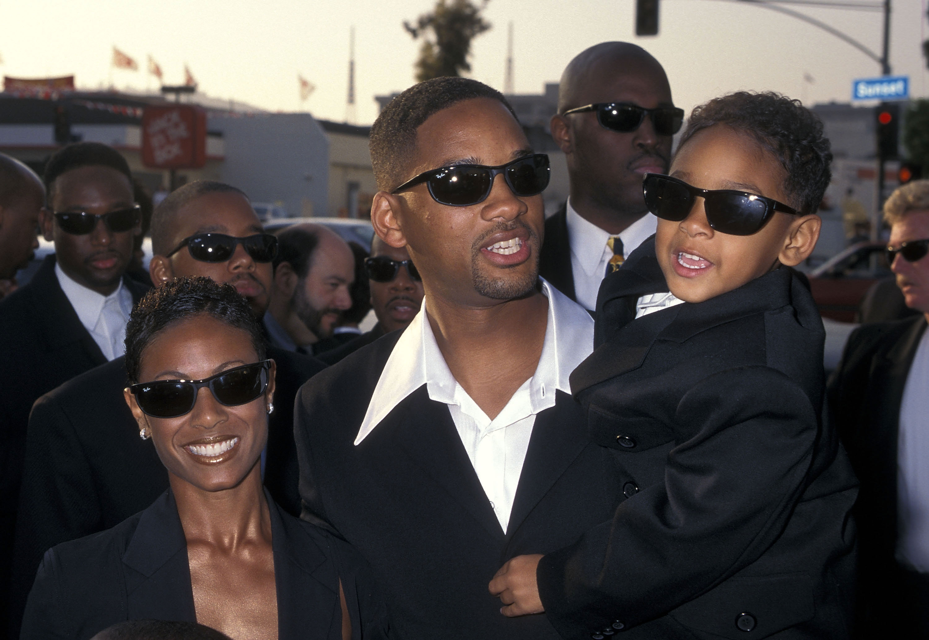 Will Smith carrying a young Jaden Smith with Jada Pinkett Smith by his side.