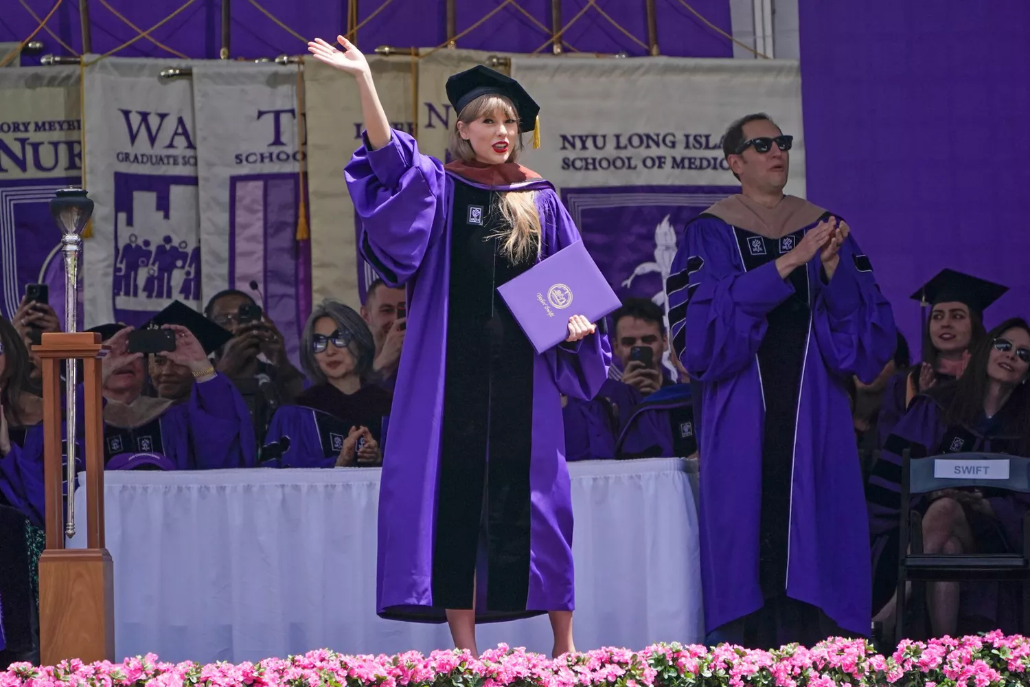 Taylor Swift waves after receiving an honorary degree during a graduation ceremony for New York University at Yankee Stadium in New York, Wednesday, May 18, 2022