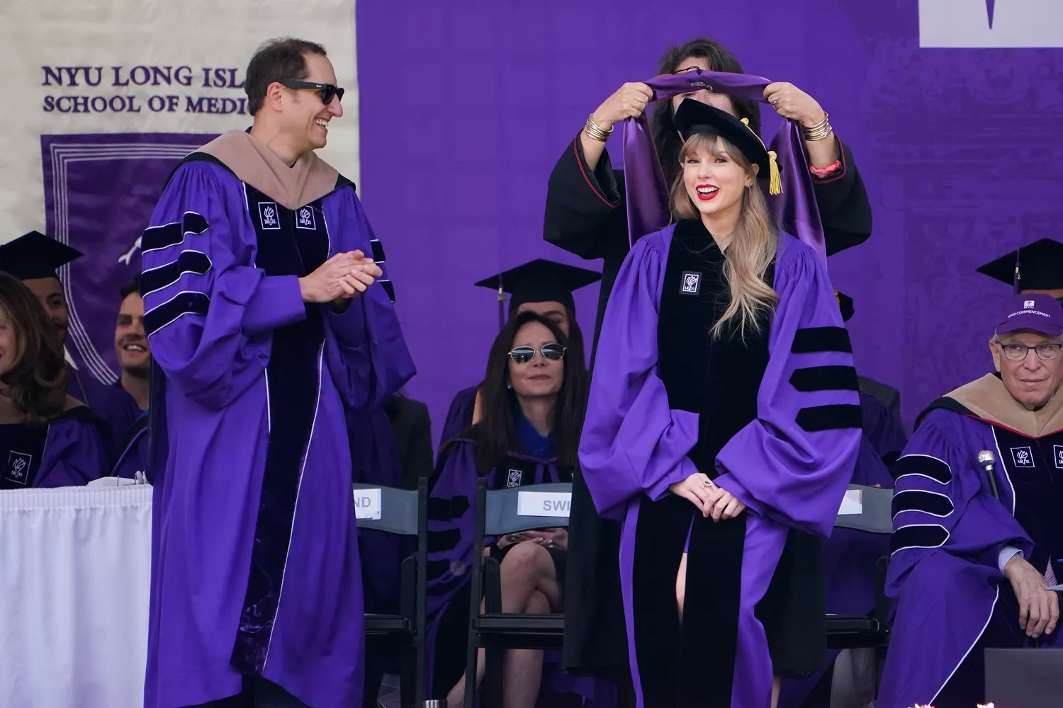 Taylor Swift, right, receives an honorary degree during a graduation ceremony for New York University at Yankee Stadium in New York, Wednesday, May 18, 2022