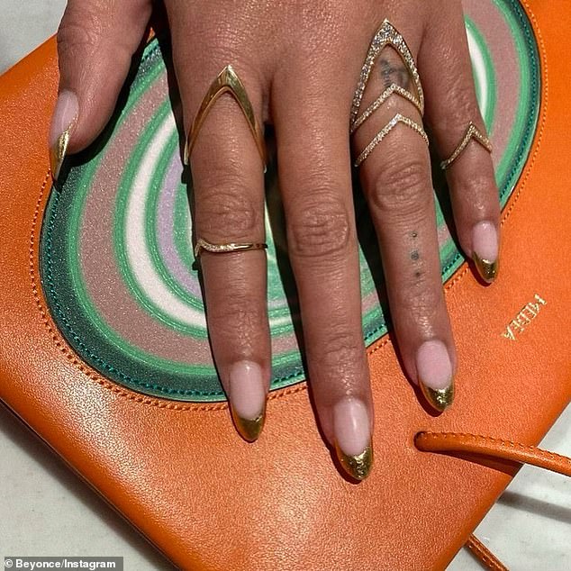 Colorful: The hitmaker complemented her clothing with an orange leather Medea handbag with a green striped vortex print which retails for close to $1,000