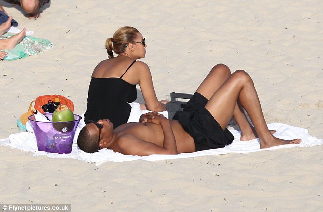 Winding down: The pair appeared to have ordered a bottle of wine to help them relax during their day at the beach