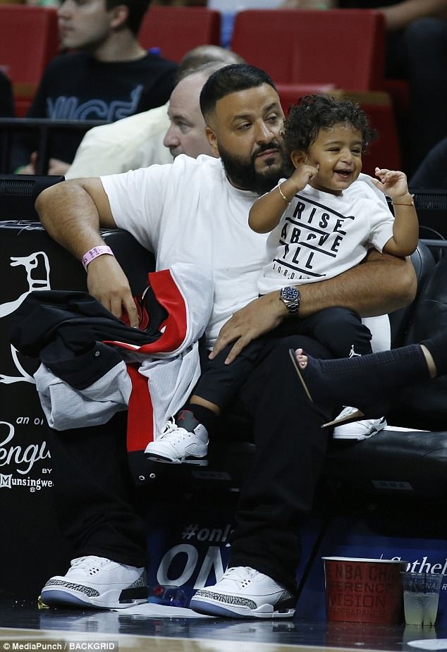 Out and about: DJ Khaled, 42, was seen holding his adorable 17-month-old son Asahd in their courtside seats at the Miami Heat game at the AmericanAirlines Arena Monday 