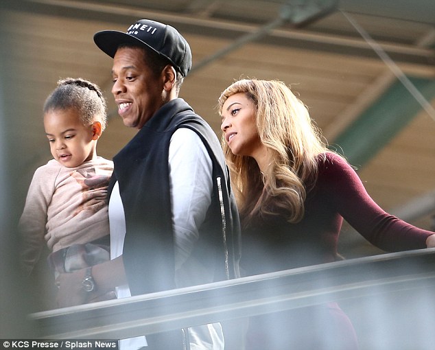 Daddy's girl: Blue looked happy to be in her daddy's arms as the family rode the escalator down from the platform at St Pancras