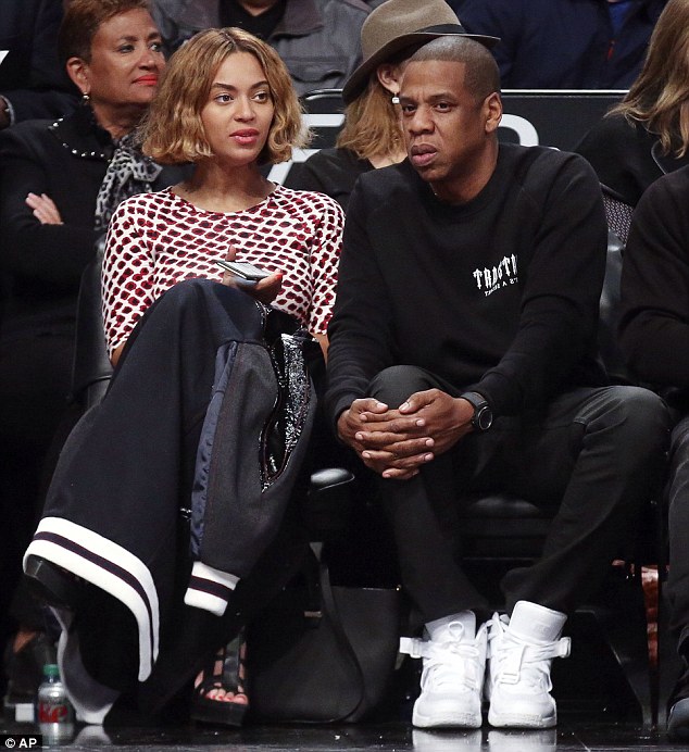 No more bangs: Beyonce was flawless as usual in the chin length blunt 'do as she cosied up next to husband Jay-Z at the Nets game in Brooklyn on Monday