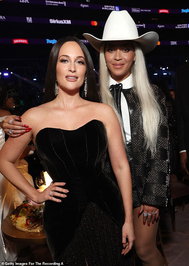 Beyoncé stunned in a checker-print leather blazer with matching shorts. The lighter squares were created with rows of silver sequins that gleamed in the light; pictured with Kacey Musgraves (L)