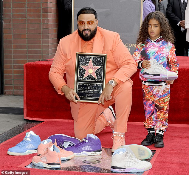 Stylish: For the special occasion, the All I Do Is Win hitmaker sported an orange suit and matching sneakers to the ceremony.