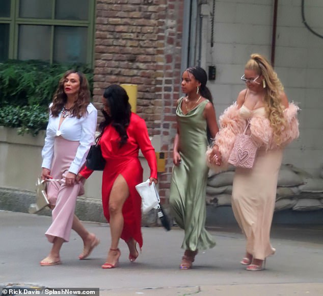 Nice earrings! The 11-year-old Grammy-winning producer - who currently serves back-up dancing duties for her famous 41-year-old mother - wore a green silk dress as she strutted down a Big Apple street with her grandmother Tina Knowles Lawson (L) and another lady (2-L)