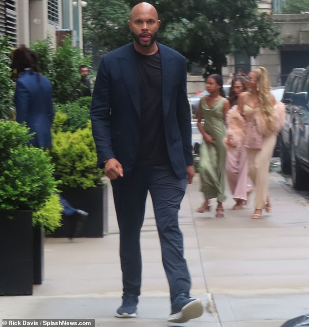 Patriarch: Knowles-Carter's husband of 15 years - Roc Nation rap mogul Jay-Z (L) - opted for a sleek blue tailored suit and necktie as he entered the building ahead of the ladies