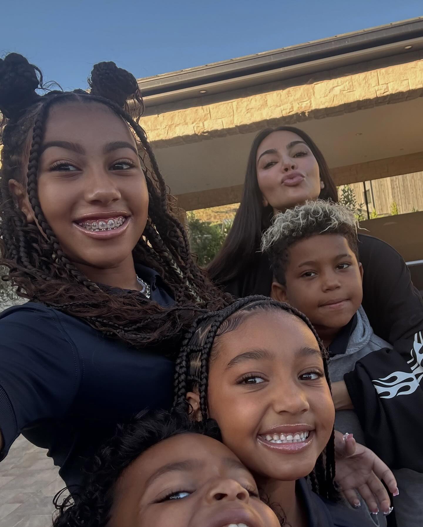 Photo by Kim Kardashian on September 17, 2024. May be a selfie of 4 people, child, braids, makeup, people smiling and text.